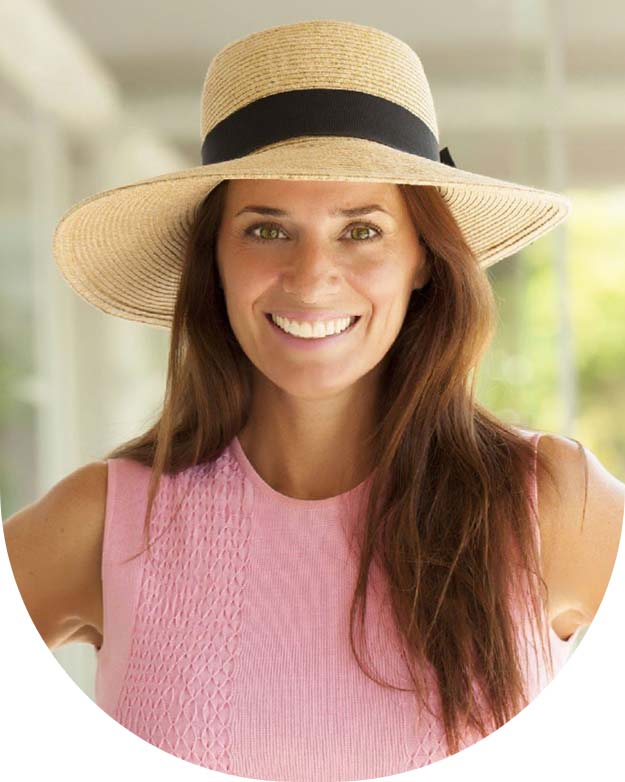 middle-aged woman wearing straw hat laughing stock image