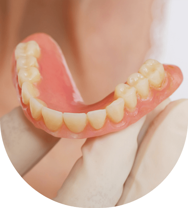 removable denture in the hands of a doctor stock image