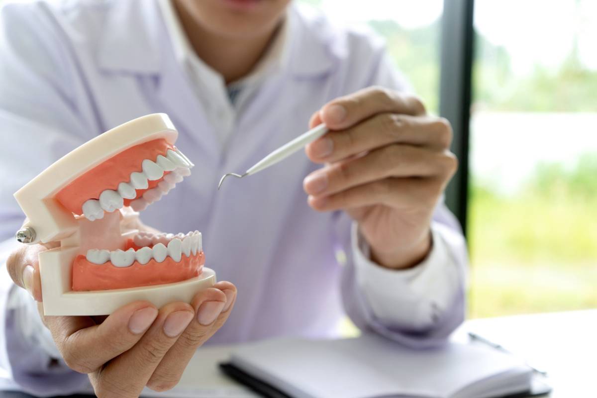 dentist explaining dentures mistakes to avoid