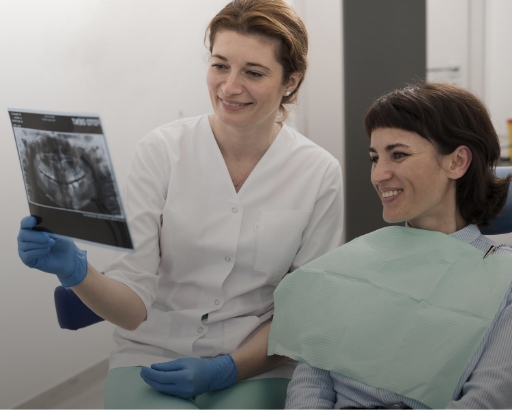 female doctor holding an X-ray of tooth extractions stock image