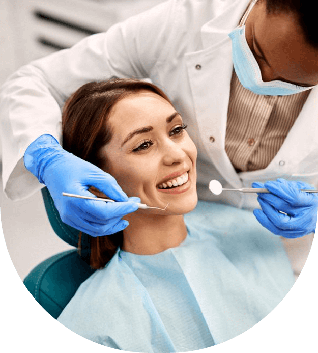 Smiling woman getting her teeth checked by dentist stock image